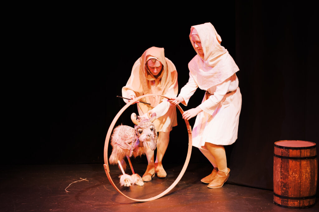 Figure 2. Is it a goat at a barrel hoop, or is it the Demon Baphomet about to enter an interdimensional portal? Pictured: Alex Vernon and Sarah Olmstead Thomas. (Photo: Leah Huete)