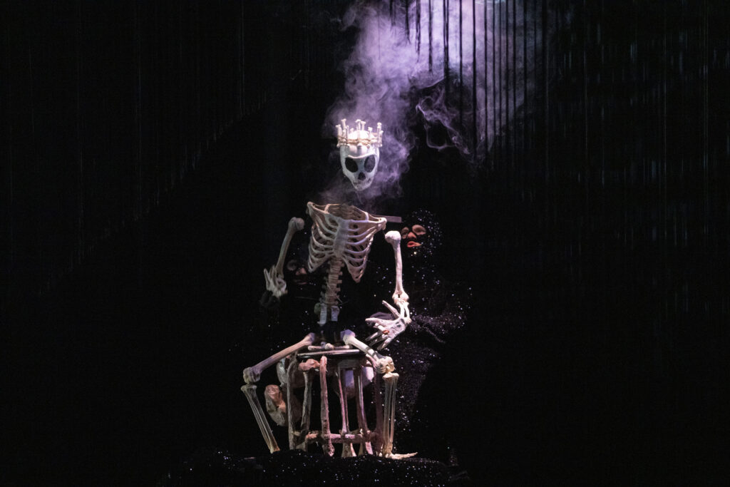 Figure 6. The Bone King, terrified of vanishing, attempts to control all the bones of the underworld in Dead as a Dodo. Wakka Wakka ensemble. (Photo: Richard Termine)