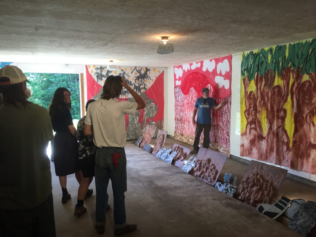 Figure 2. Puppeteer Paul Zaloom improvising a bedsheet painting narrative as part of an exhibition at the Bread and Puppet Theater’s Porter Barn, in The Heart of the Matter Circus and Pageant in Glover, Vermont, in July 2023. (Photo: John Bell)