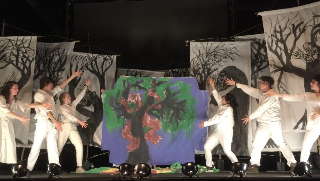 Figure 8. “But together many trees create an ecosystem.” From a performance 
of Inflammatory Earthling Rants (With Help from Kropotkin), with the “Tree Series” #4 bedsheet painting, performed at The Armory, Somerville, Massachusetts, April 21, 
2023. (Photo: John Bell)