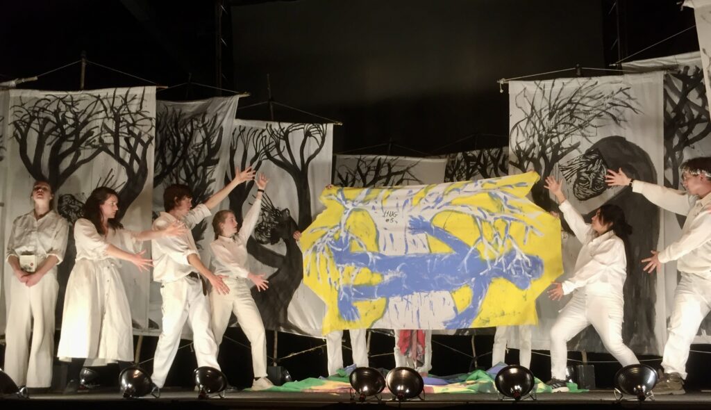 Figure 9. “If every tree were looking out only for itself, then quite a few of them would never reach old age.” From a performance of Inflammatory Earthling Rants (With Help from Kropotkin), with an unnumbered “Tree Series” bedsheet painting, performed at The Armory, Somerville, Massachusetts, April 21, 2023. (Photo: John Bell)