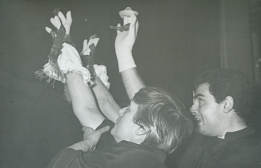 Figure 2. Mane Bernardo and Santiago Doria performing a pantomime of hands from behind the curtain. (Photo: Courtesy of Archivo del Museo Argentino del Títere)